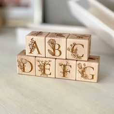 wooden blocks with letters and flowers on them