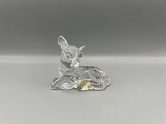 a glass dog figurine sitting on top of a table