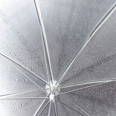 an open umbrella with water drops on it