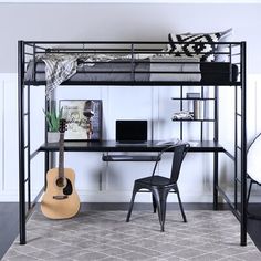 a bunk bed with a desk underneath it and a guitar on the floor next to it