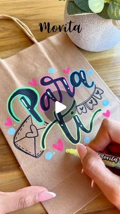 someone is drawing on a brown paper bag that says pate - n - fly