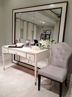 a white desk with a mirror and chair