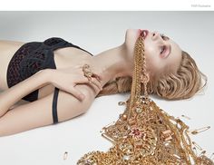 a woman laying on the ground with some jewelry