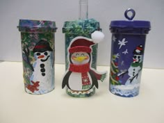 three different cups with snowmen on them and one has a penguin in the middle