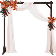 an arch decorated with flowers and white drapes