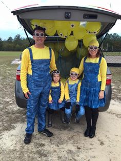 a family dressed up as minions from the movie despicable me standing in front of their car