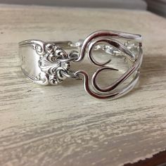 a silver ring sitting on top of a wooden table