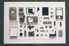 an assortment of electronic components displayed on a white sheet with wood grained flooring