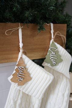 two christmas stockings hanging from a wooden hanger