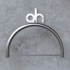 a stainless steel towel ring with a pair of scissors on the top and two holes in the middle