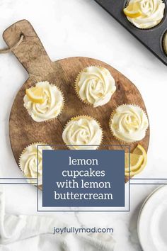 lemon cupcakes with lemon buttercream on a cutting board