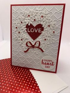 a red and white card with a heart on it