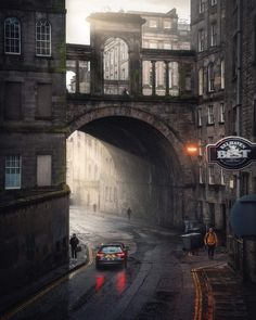 a car driving under an overpass on a rainy day