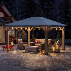 a gazebo with christmas lights on it in the middle of a snow covered yard