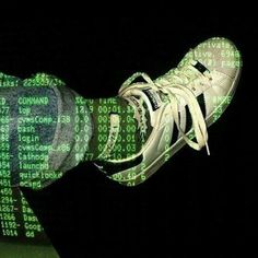 a person's feet with green and black numbers on them in front of a computer screen