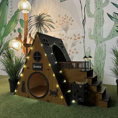 a house made out of cardboard with lights on it