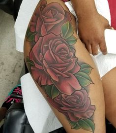 a woman's leg with roses and leaves on it