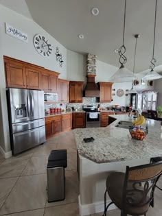 a large kitchen with stainless steel appliances and granite counter tops, along with wooden cabinets