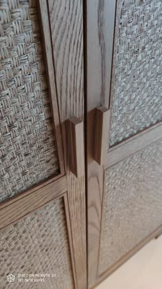 closeup of the handles and sides of a wooden cabinet with wicker pattern on it