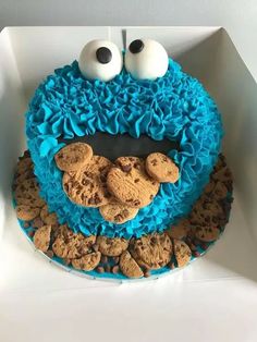 cookie monster cake with eyes and cookies on top