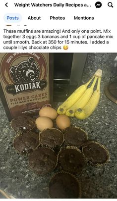 some chocolate muffins and bananas on a counter with a carton of milk