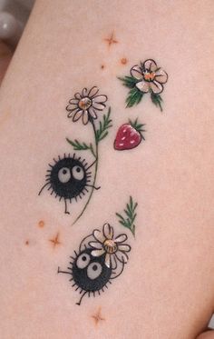 a woman's stomach with tattoos on it and daisies in the shape of ladybugs