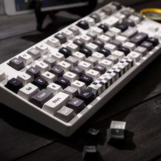 a computer keyboard sitting on top of a wooden table