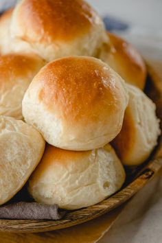 a basket filled with rolls sitting on top of a table