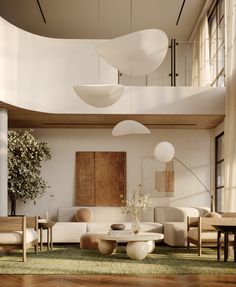 a living room filled with lots of furniture next to a tall ceiling mounted above a wooden floor