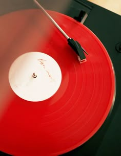 an old record player with red and black vinyl