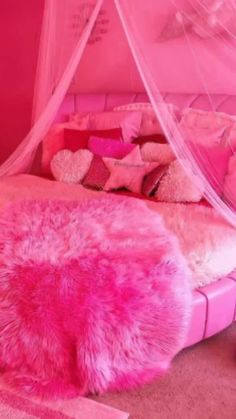 a pink bed with a canopy over it