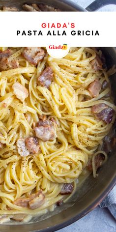 a pan filled with pasta and bacon on top of a table