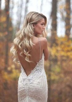 a woman with long blonde hair wearing a wedding dress