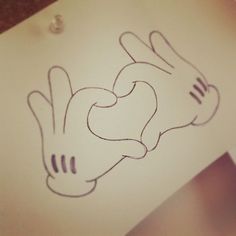 a drawing of two hands holding each other in the shape of a heart on a piece of paper