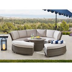 an outdoor patio furniture set with blue and white pillows