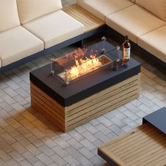 a fire pit sitting on top of a wooden table