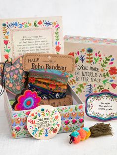 the box is filled with colorful items and has a message inside it that says, you make a beautiful world