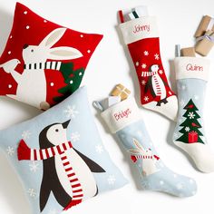 three christmas stockings, one penguin and the other snowman