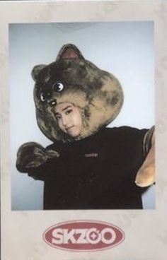 a person in a bear costume holding onto a teddy bear's head with the caption skigo