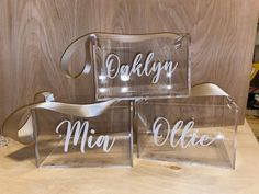 three clear acrylic boxes with the word mr and mrs written on them