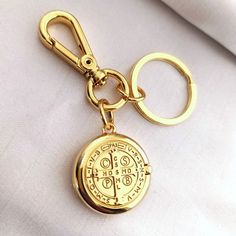 a gold keychain with an emblem on it