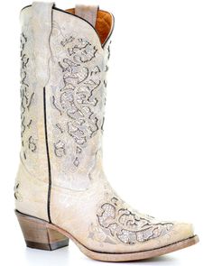 a pair of white cowboy boots sitting on top of each other