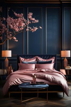 a bed with pink comforters and pillows in a dark room next to two lamps