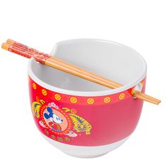 a bowl with chopsticks in it on a white background