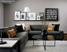 a living room filled with lots of furniture and pictures on the wall above it's coffee table