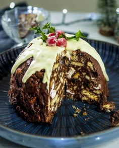 a chocolate cake with white frosting on a blue plate