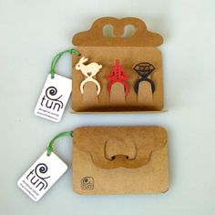 three pieces of paper with different designs on them and tags attached to each other,