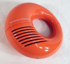 an orange radio sitting on top of a white table