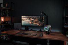 a computer desk with a monitor and keyboard on it in front of a bookshelf