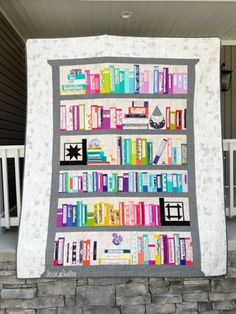 a quilted book shelf with many books on it